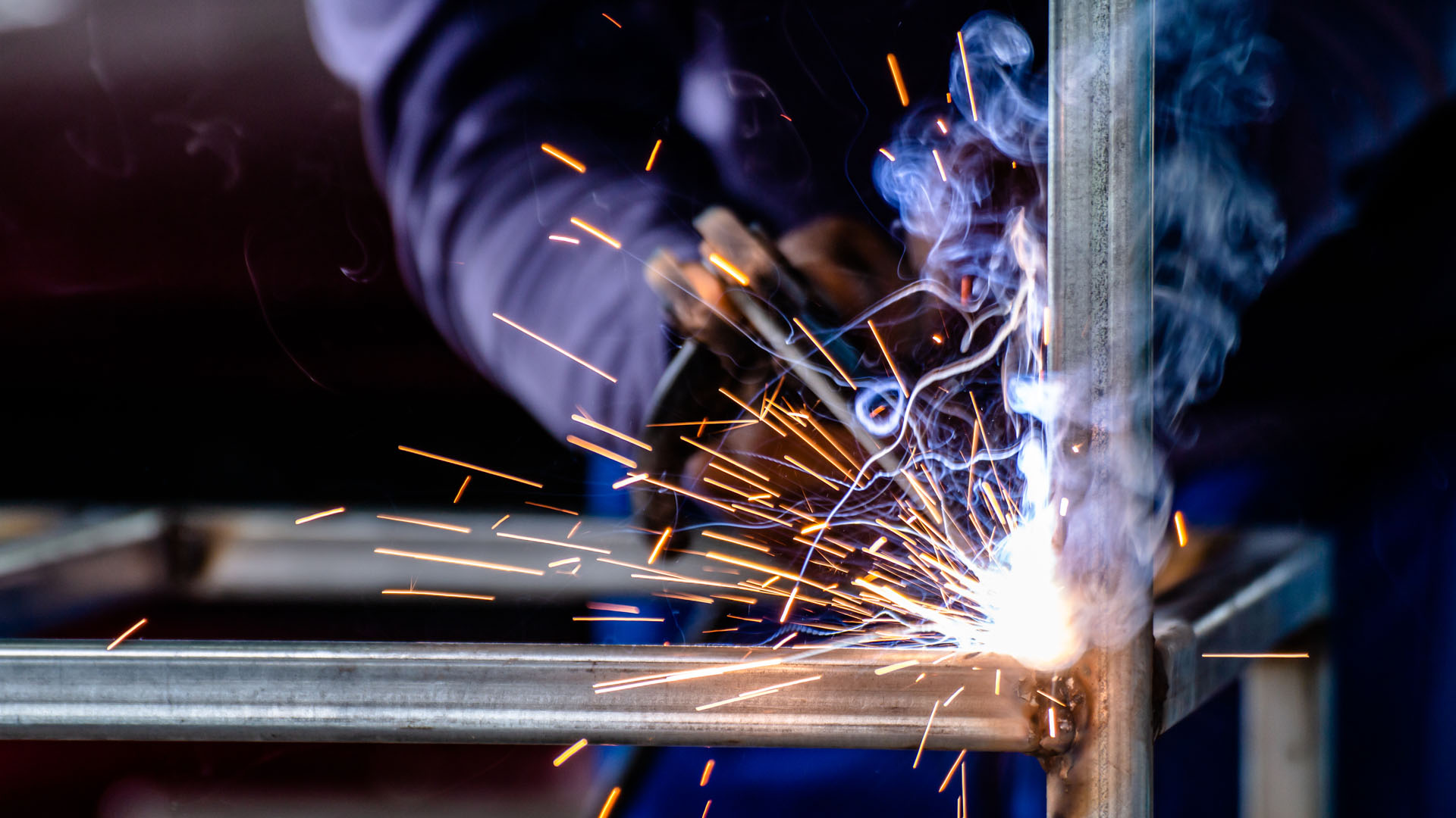 Fabricated steel components staged inside the WELDEXX shop